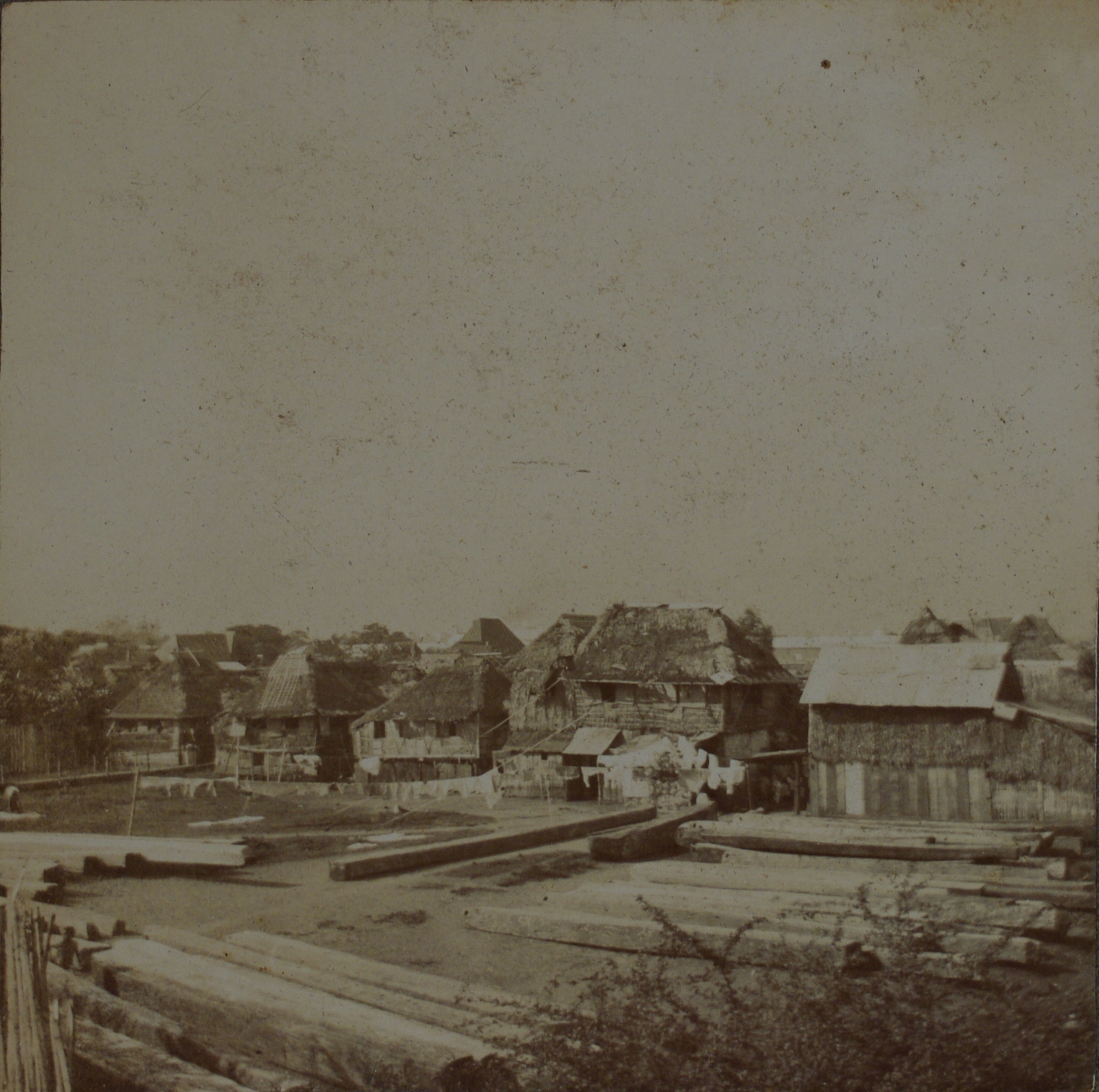 [Untitled – Village and squared logs].