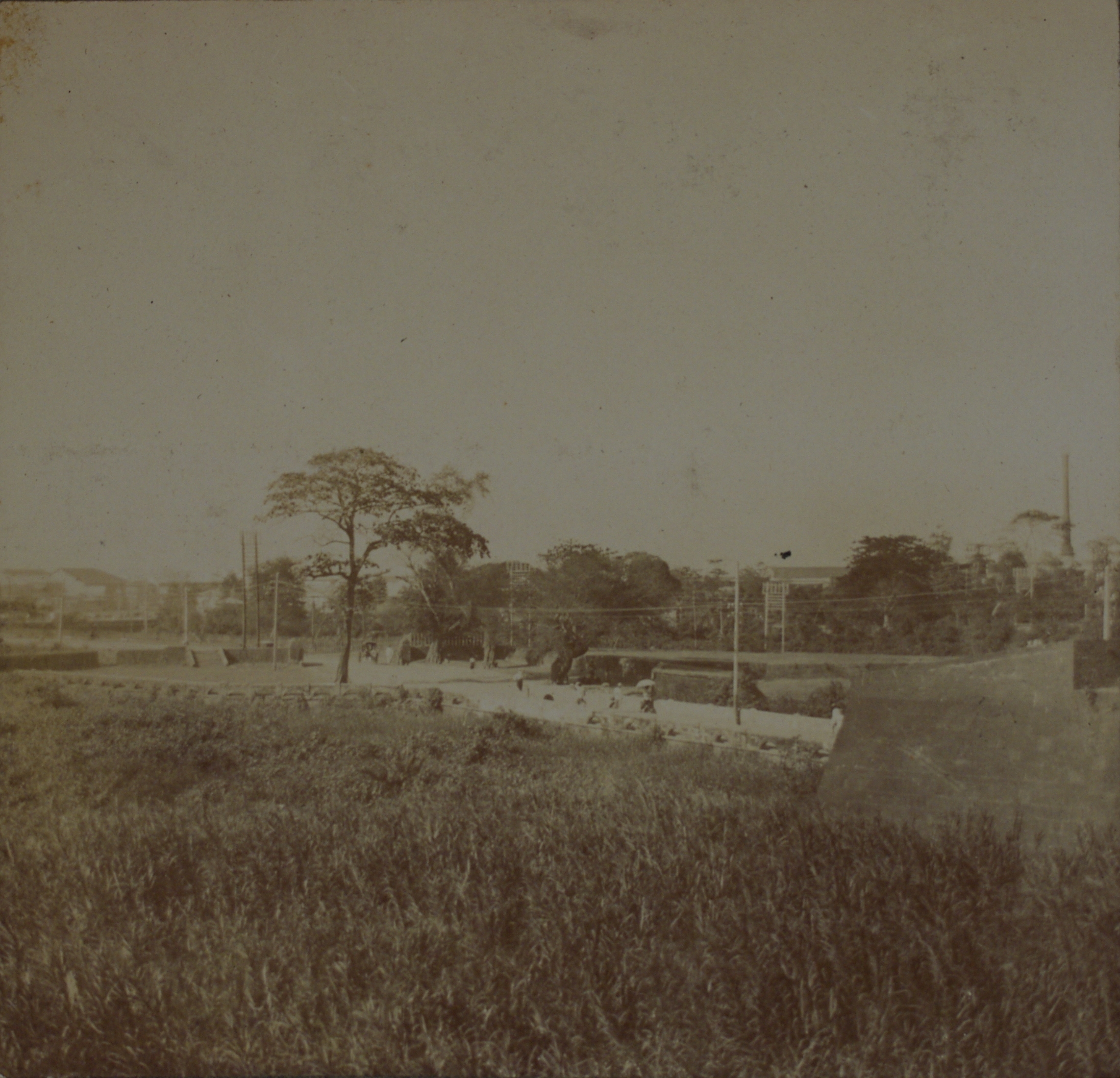 [Untitled – Pedestrians on street through fort].