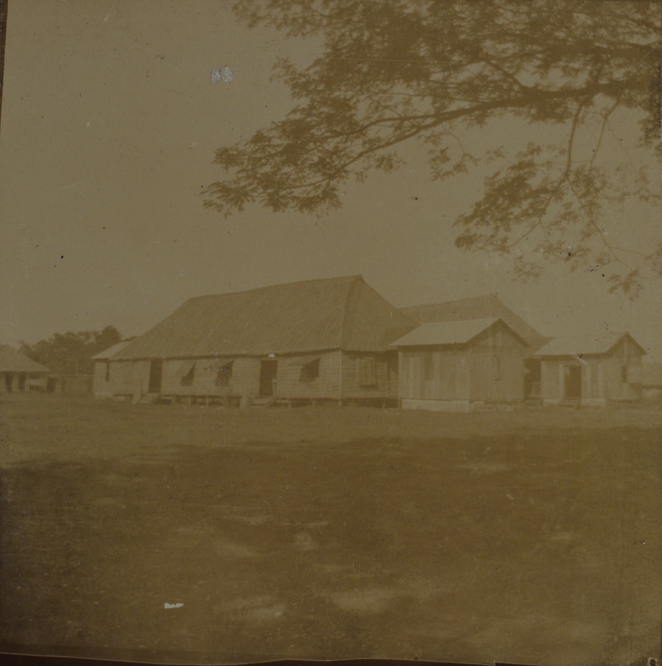 [Untitled – Large nipa structures. Barracks?].