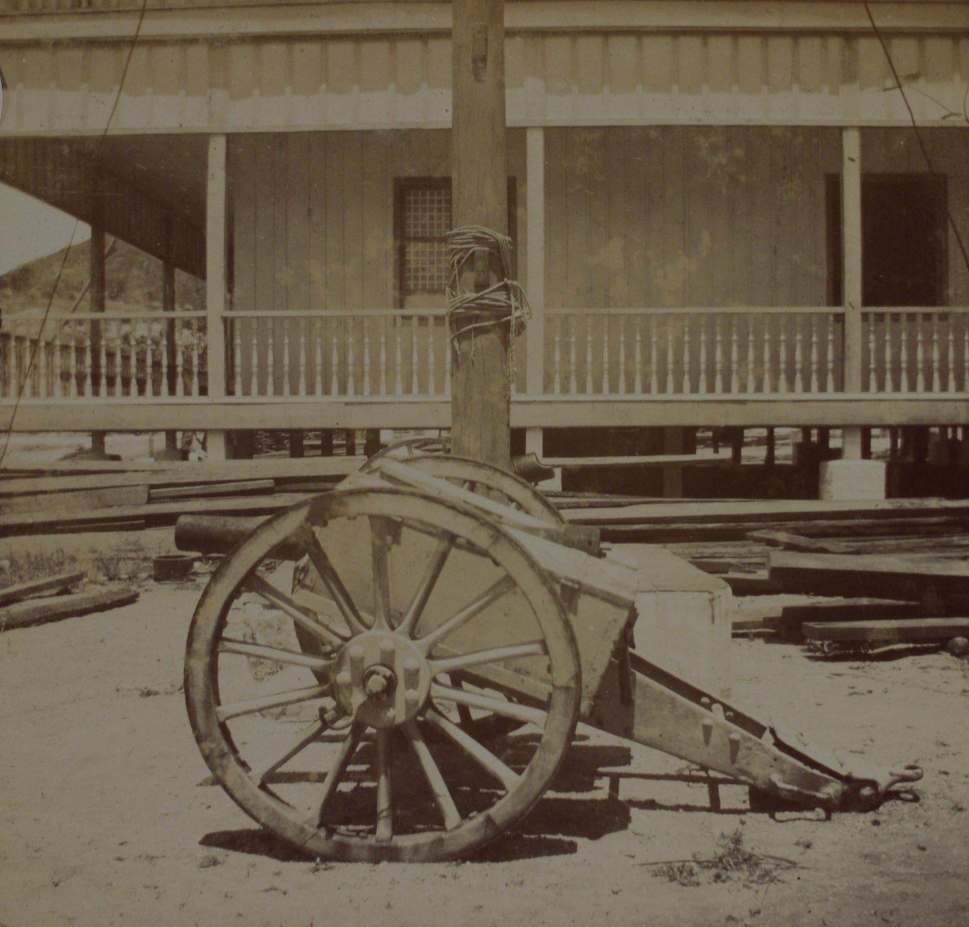 [Untitled – Cannon outside a building].