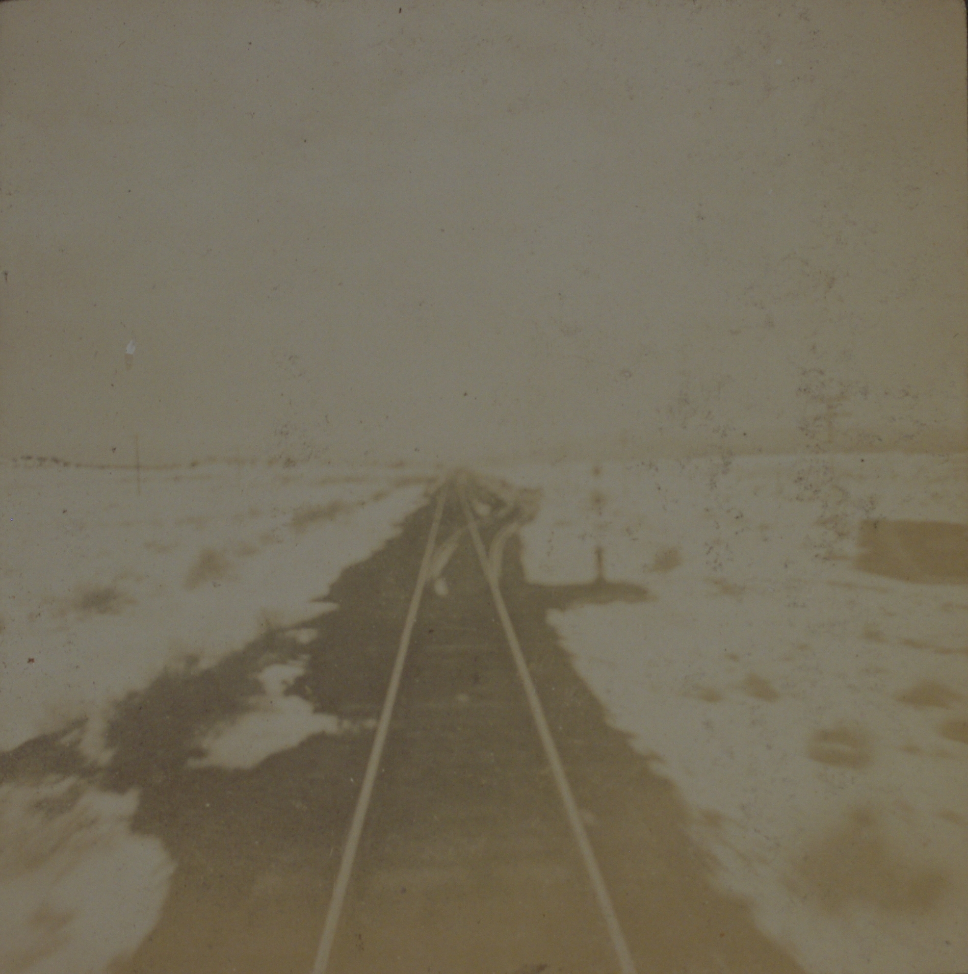 [Untitled – Railroad tracks through a snowy field, United States].
