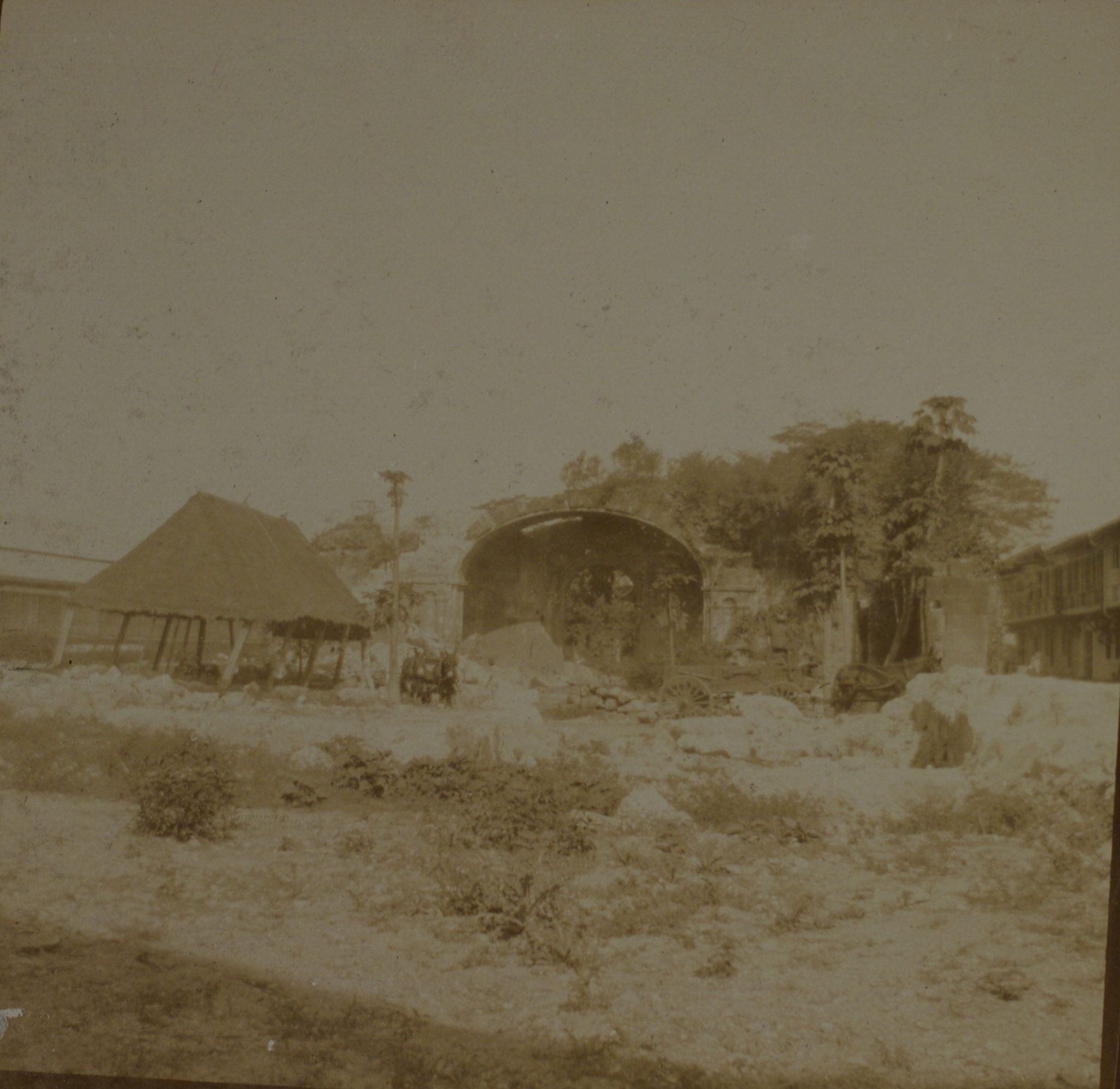 [Untitled – Thatched roof outside unidentified ruins].