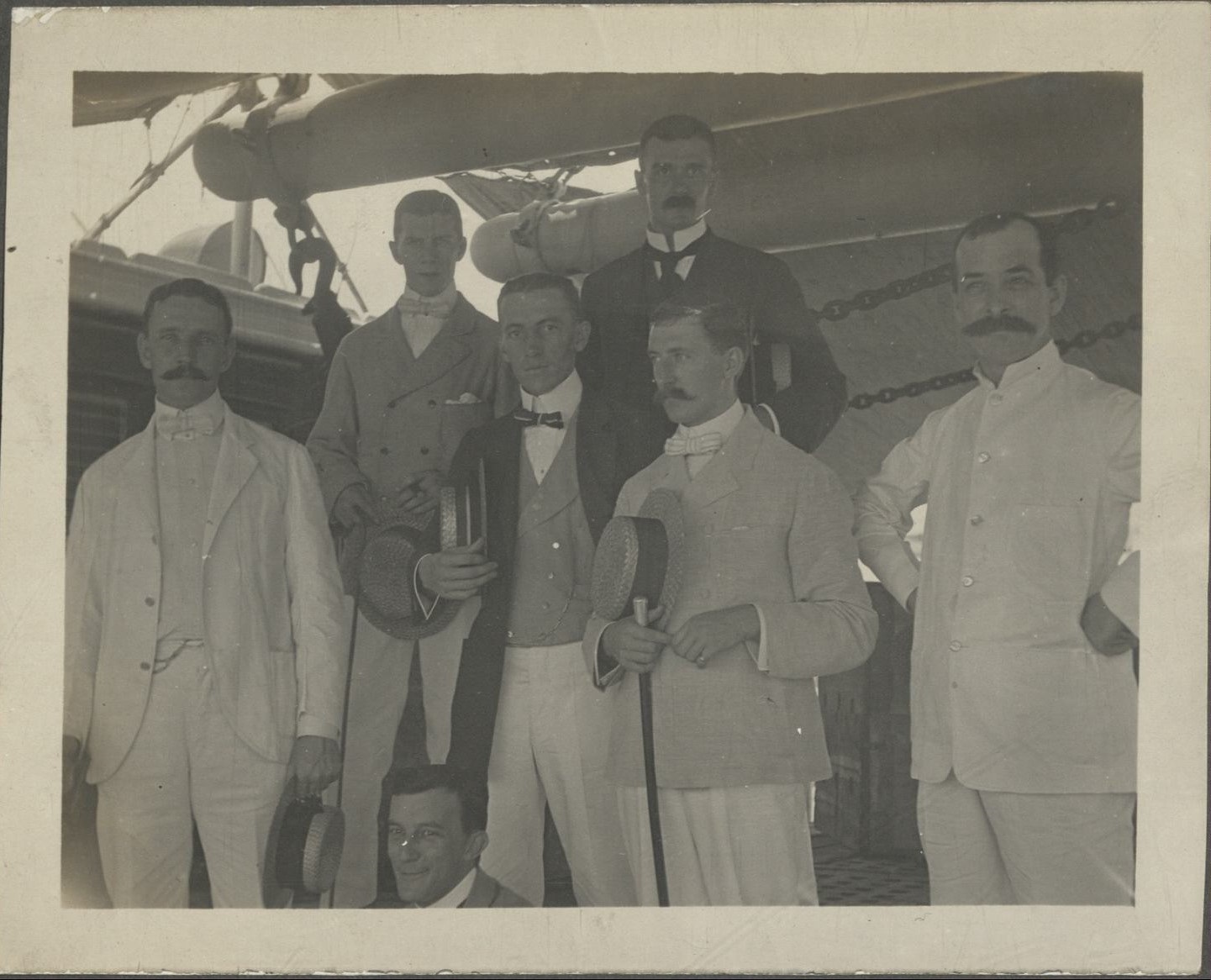 [Untitled – Six expatriate men pose on board a ship].