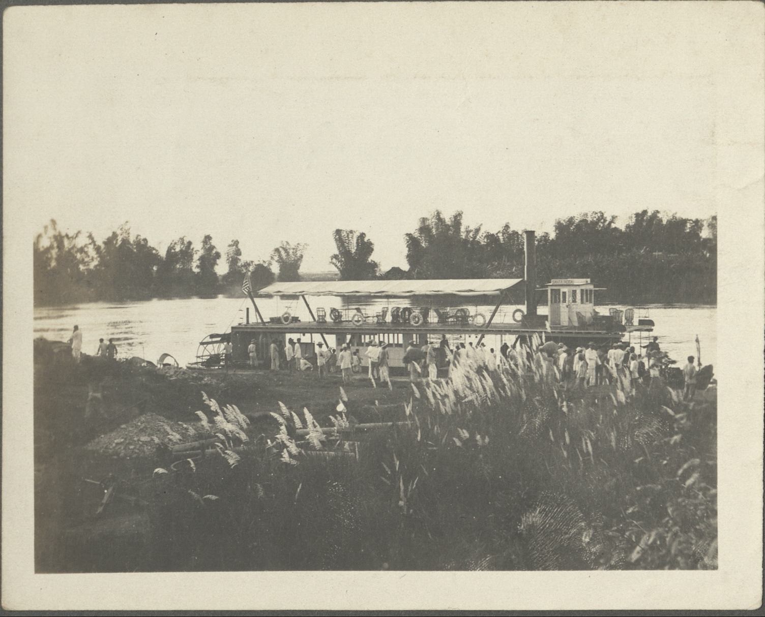 [Untitled – Sternwheeler landing on river bank].