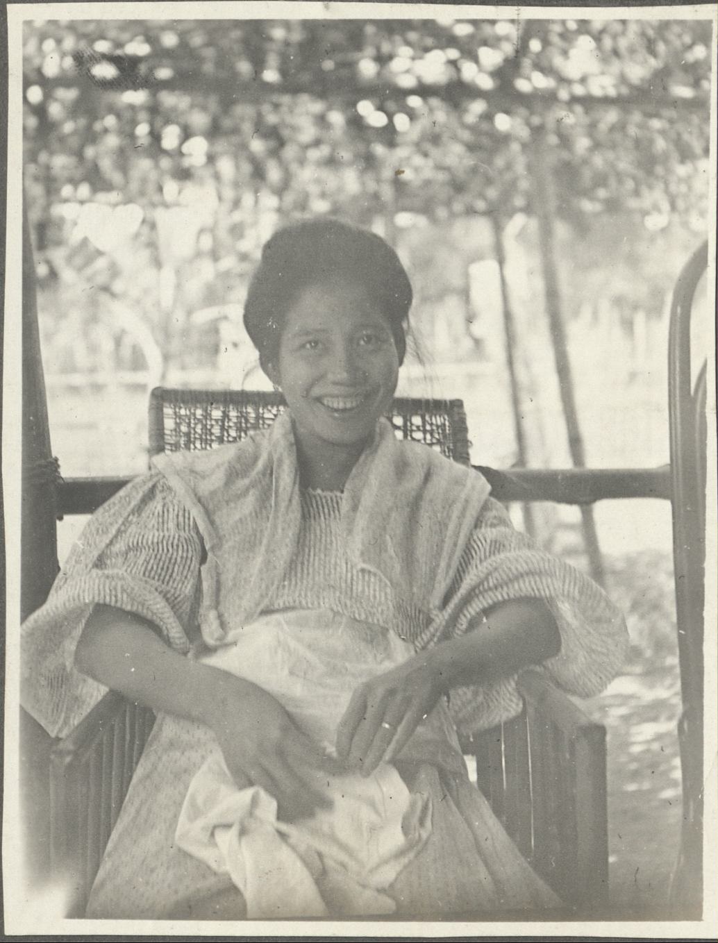 [Untitled – Filipino woman seated and smiling].