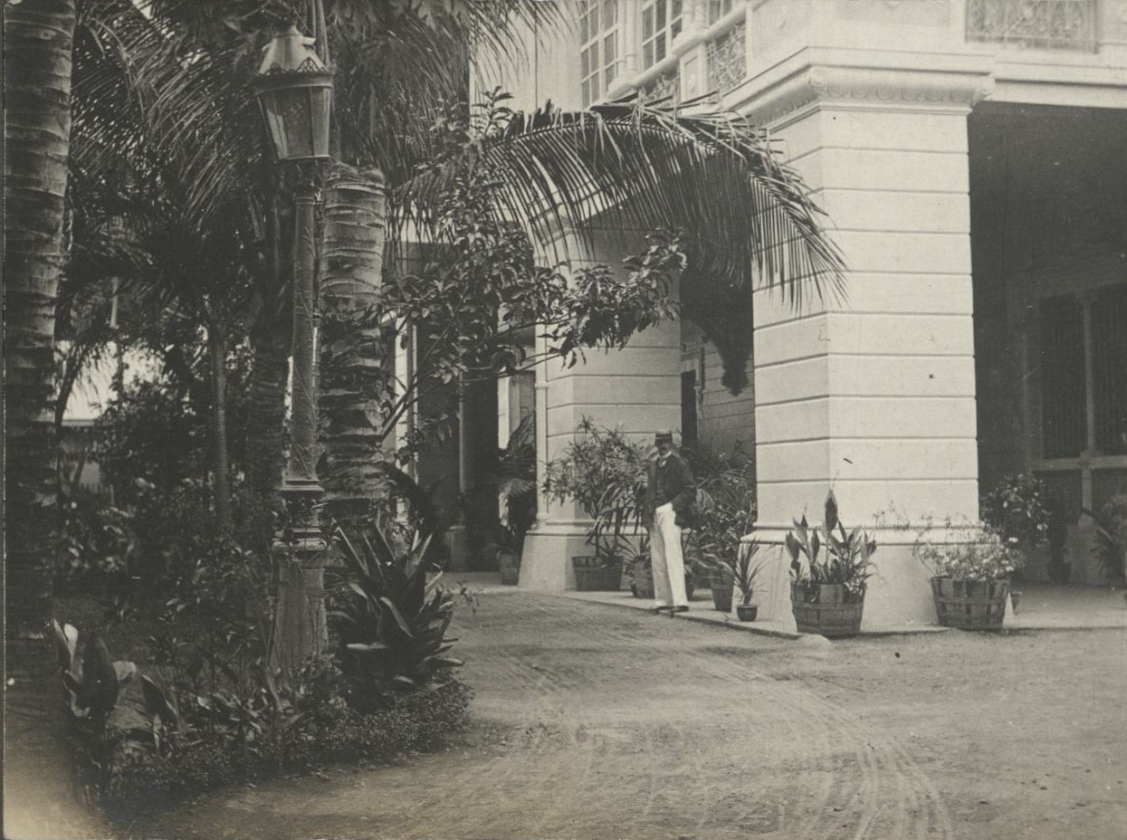 [Untitled – Expatriate man waits in driveway].