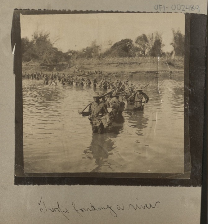 Troops fording a river.