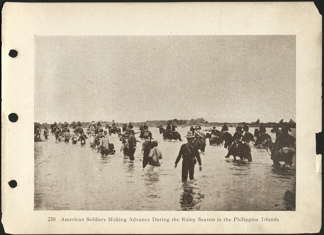 250. American soldiers making advance during the rainy season in the Philippine Islands.