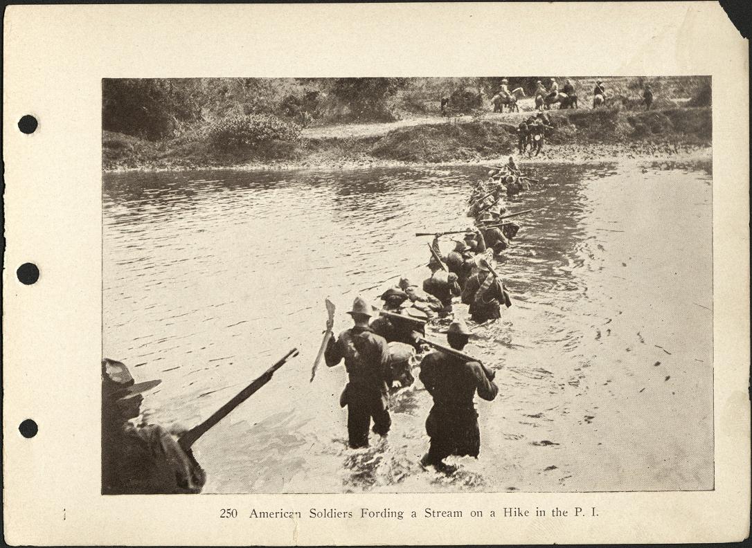 250. American soldiers fording a stream on a hike in the P. I.