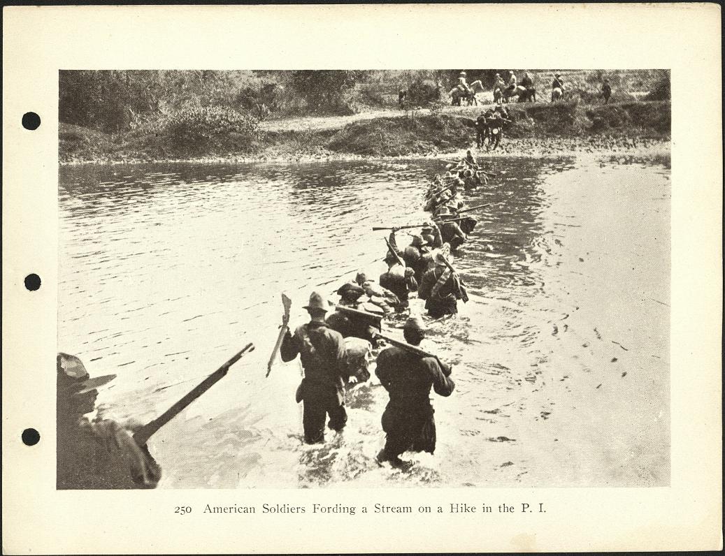 250. American soldiers fording a stream on a hike in the P. I.
