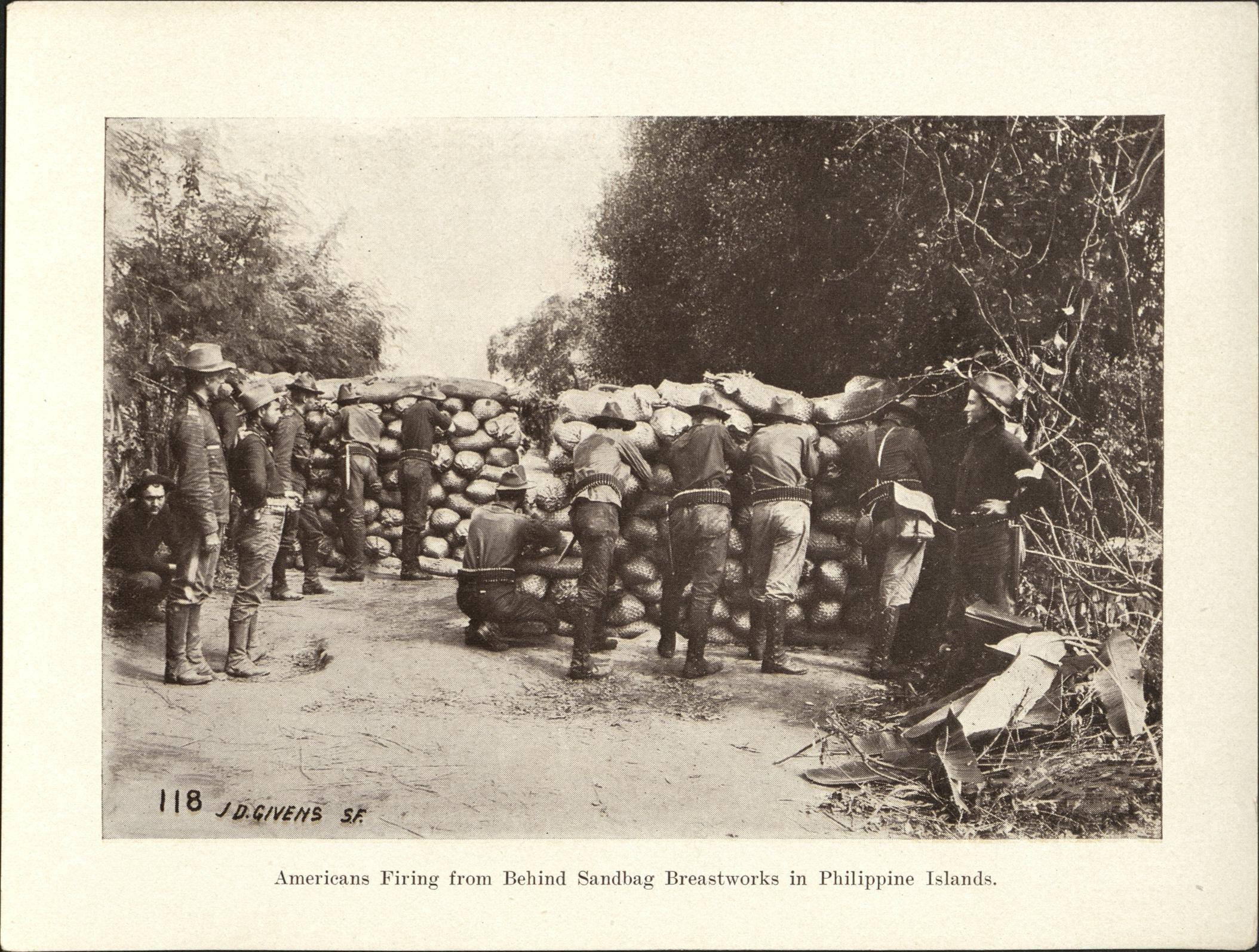 118. Americans firing from behind sandbag breastworks in Philippine Islands.