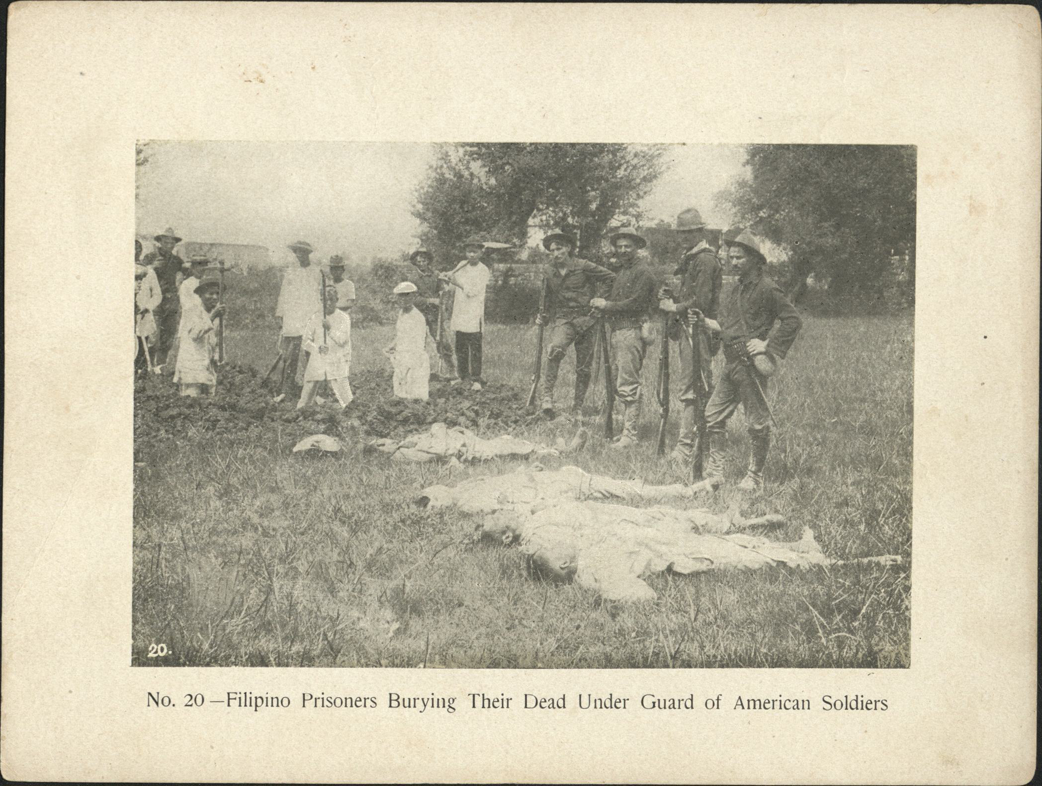 No. 20 – Filipino prisoners burying their dead under guard of American soldiers.