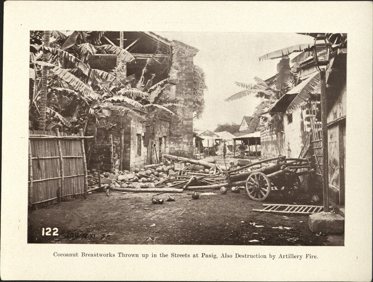 122. Cocoanut [Coconut] breastworks thrown up in the streets at Pasig. Also destruction by artillery fire.