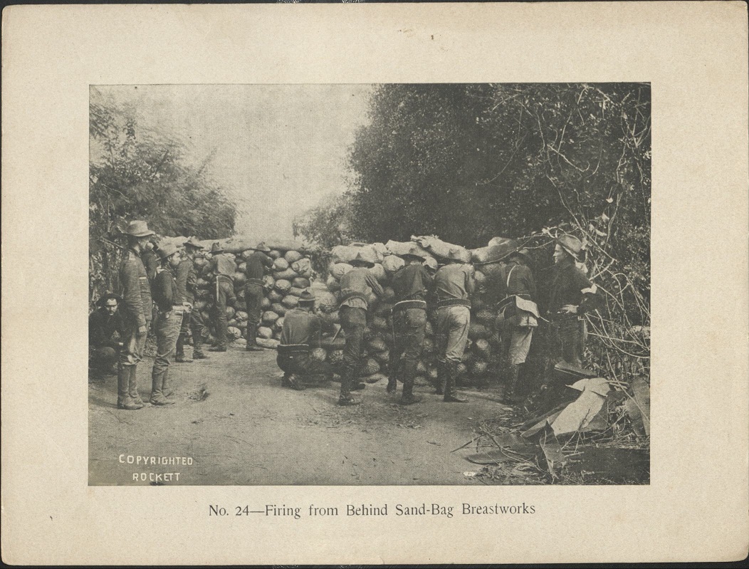 No. 24 – Firing from behind sand-bag breastworks.