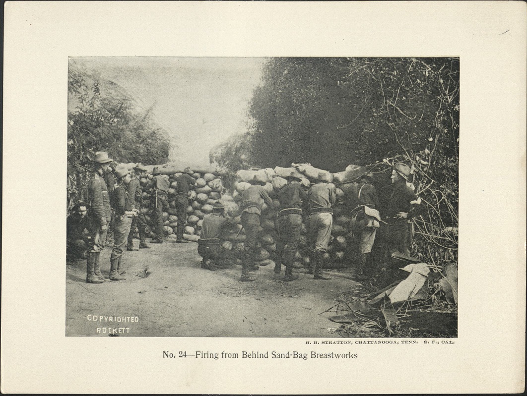 No. 24 – Firing from behind sand-bag breastworks.