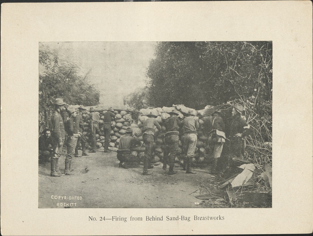 No. 24 – Firing from behind sand-bag breastworks.