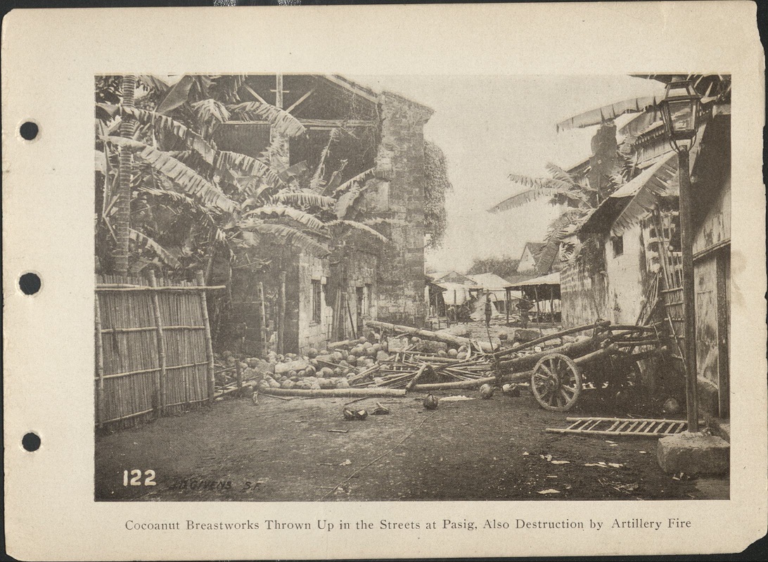 122. Cocoanut [Coconut] breastworks thrown up in the streets at Pasig. Also destruction by artillery fire.