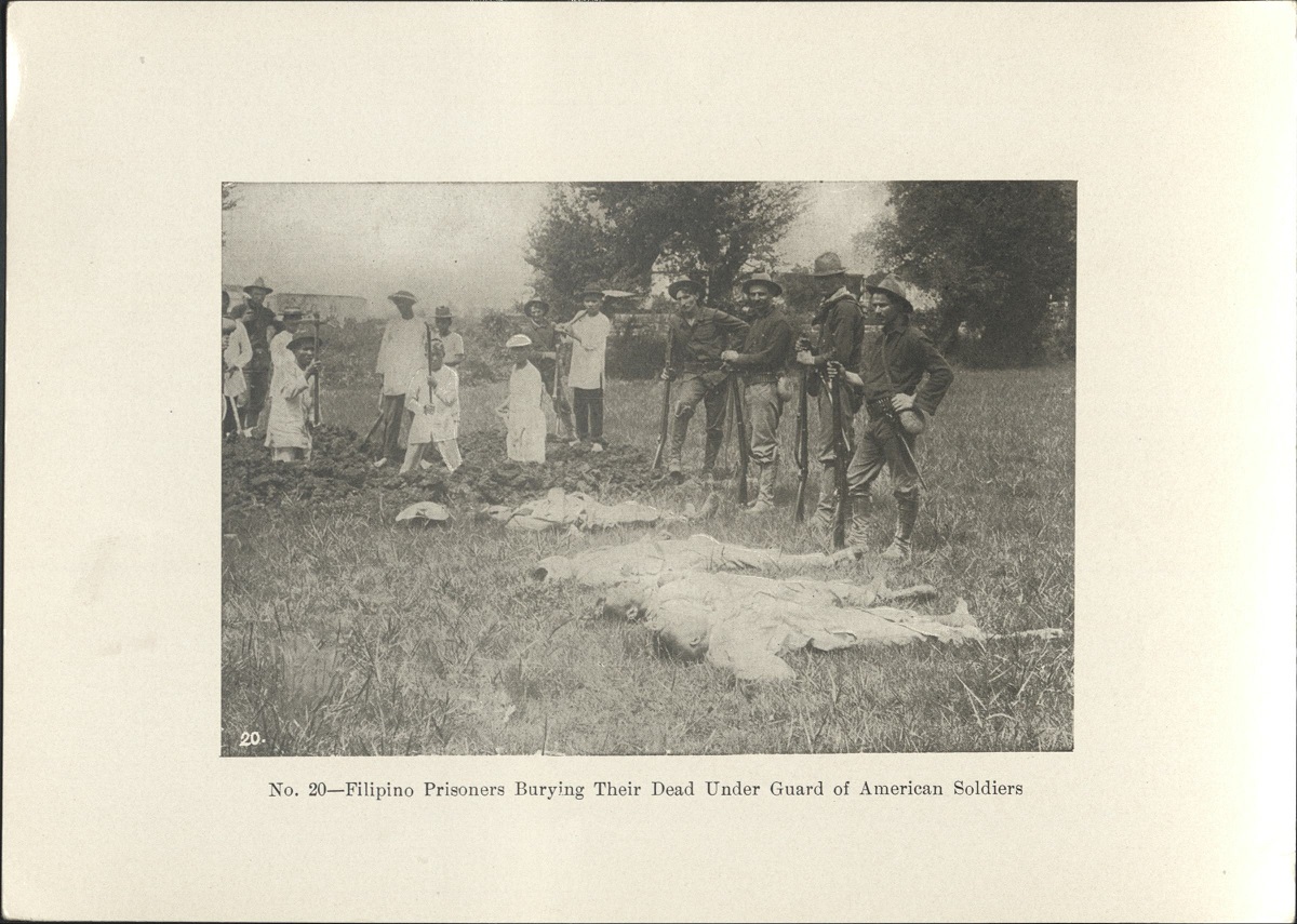 No. 20 – Filipino prisoners burying their dead under guard of American soldiers.