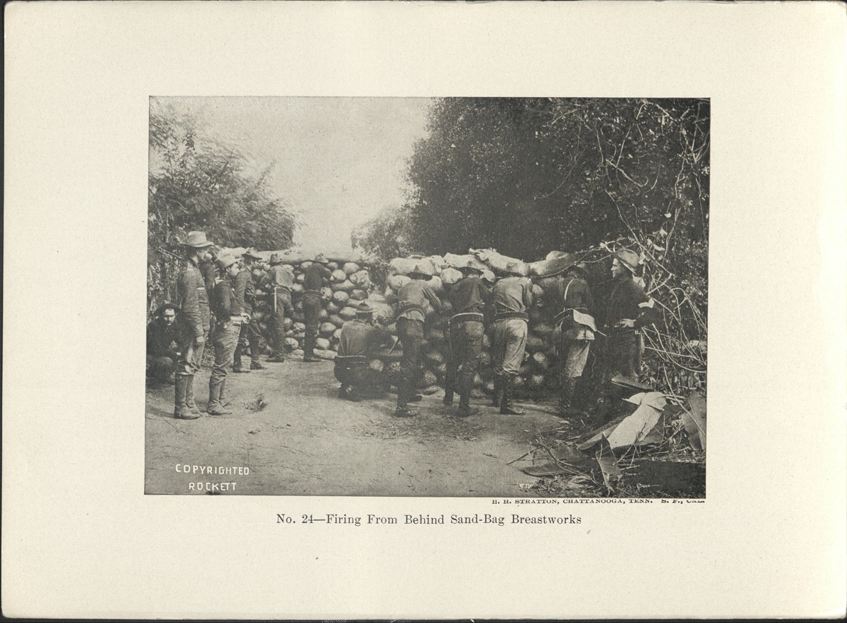 No. 24 – Firing from behind sand-bag breastworks.