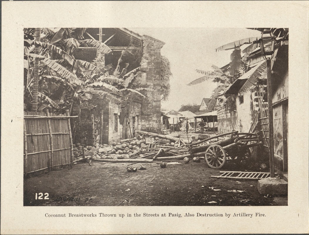 122. Cocoanut [Coconut] breastworks thrown up in the streets at Pasig. Also destruction by artillery fire.