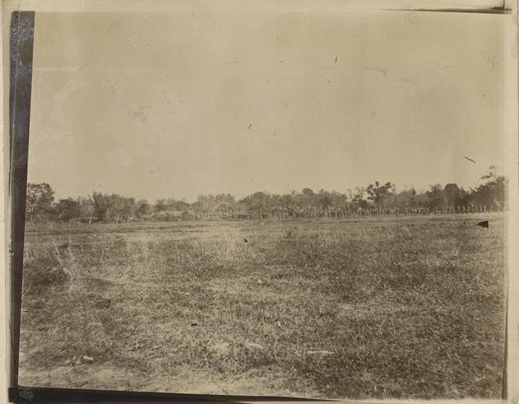 [Untitled – Soldiers marching along the edge of a field].