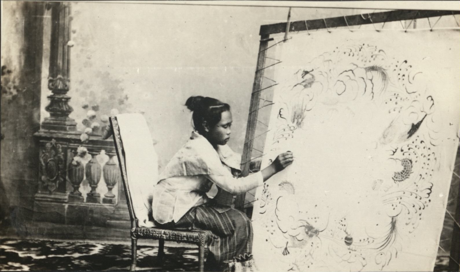 [Untitled – Filipina artist working on large stretched canvas in studio].