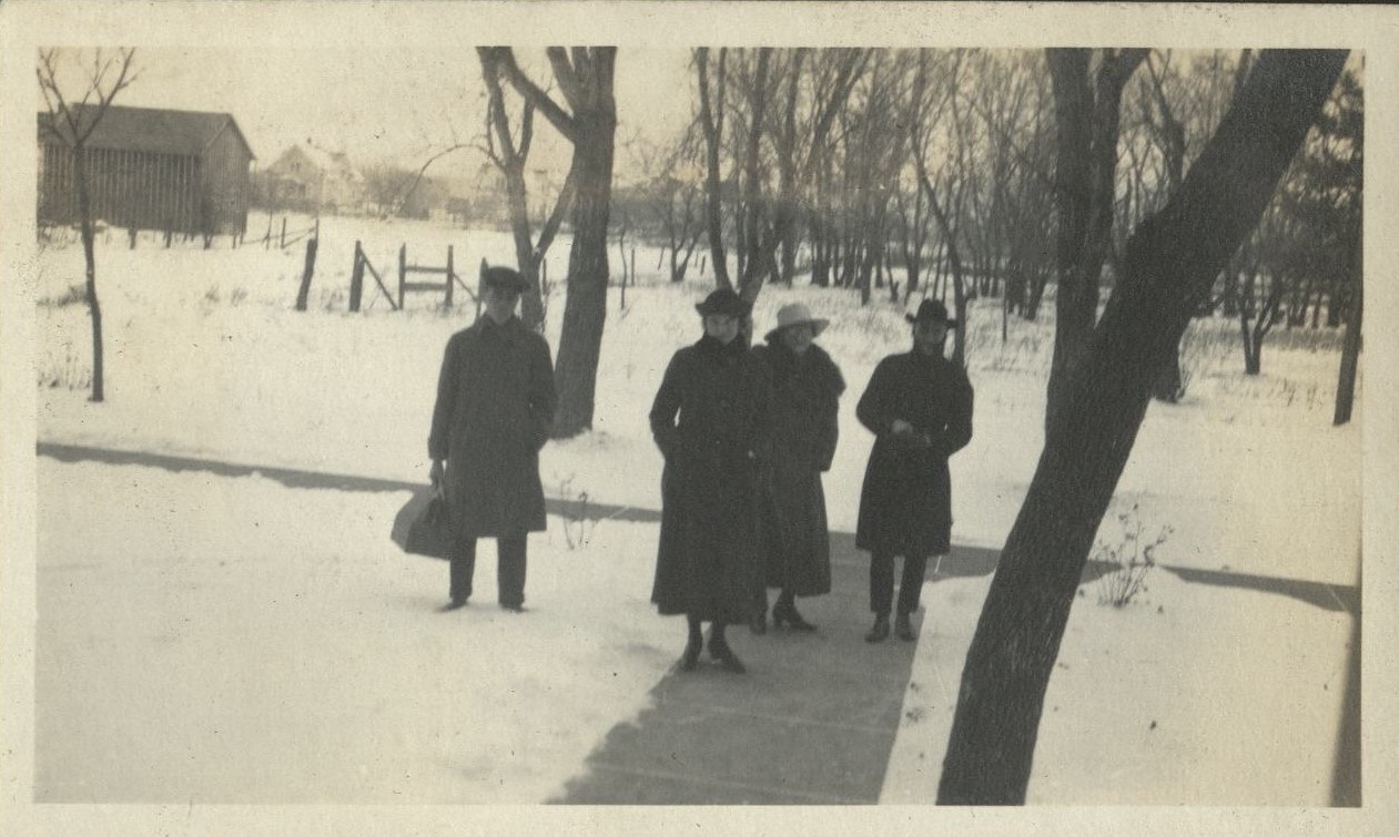 Exeter, Nebraska [Couples on a snowy sidewalk].