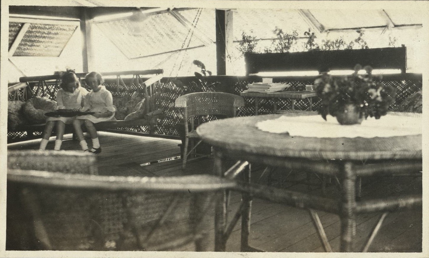 [Untitled – Steger girls reading on patio, Fort Wint, Grande Island?]