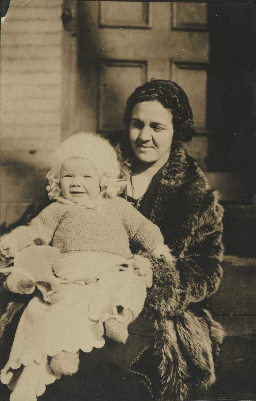 [Untitled – Mother holding infant on porch in USA – Denney’s]