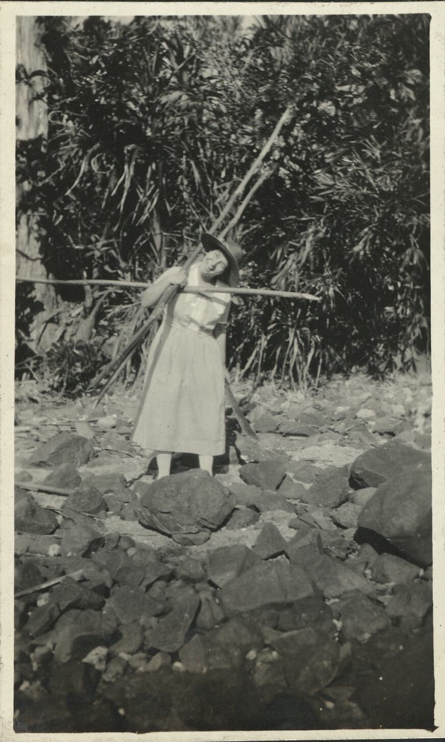 [Untitled – American woman carrying bamboo poles].
