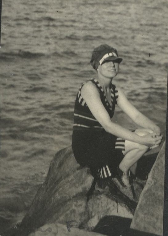 F… [Illegible – Woman on sea wall, likely at Fort Wint, Grande Island].