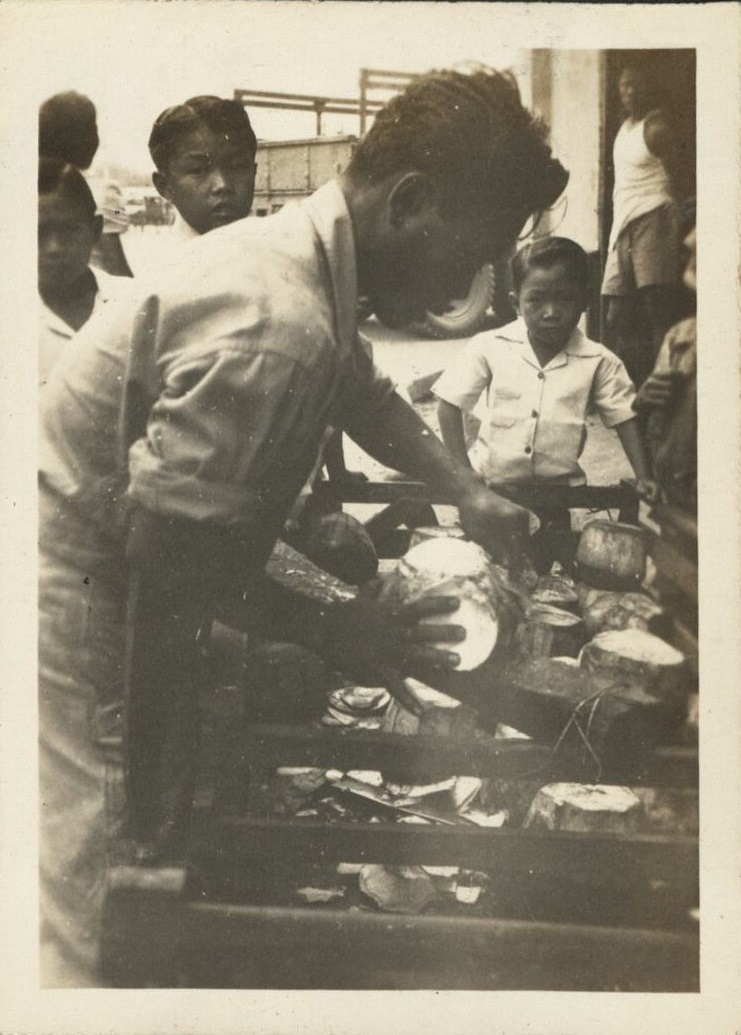 The Filipino Way – Cutting “buko” to drink.