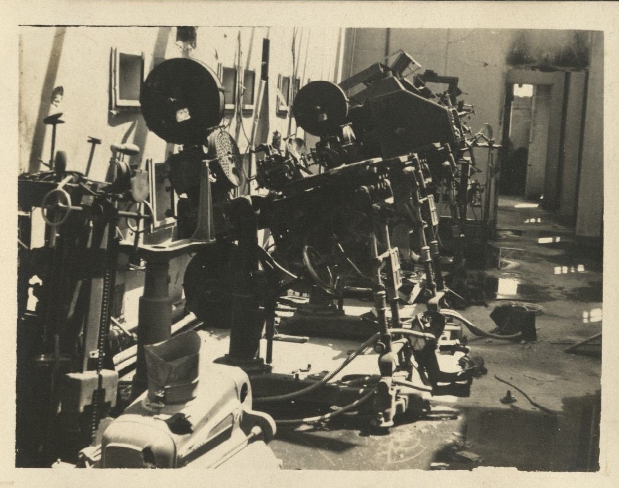 Seen around Manila. [Movie projectors in a theater projection room?].