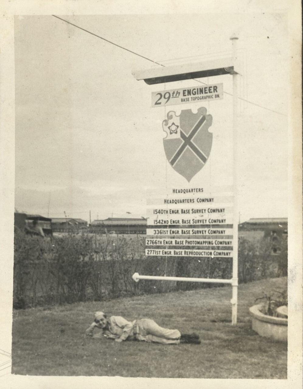 Seen around the 29th [Engineer Base Topographic Battalion. Soldier lies by Battallion directional signboard].