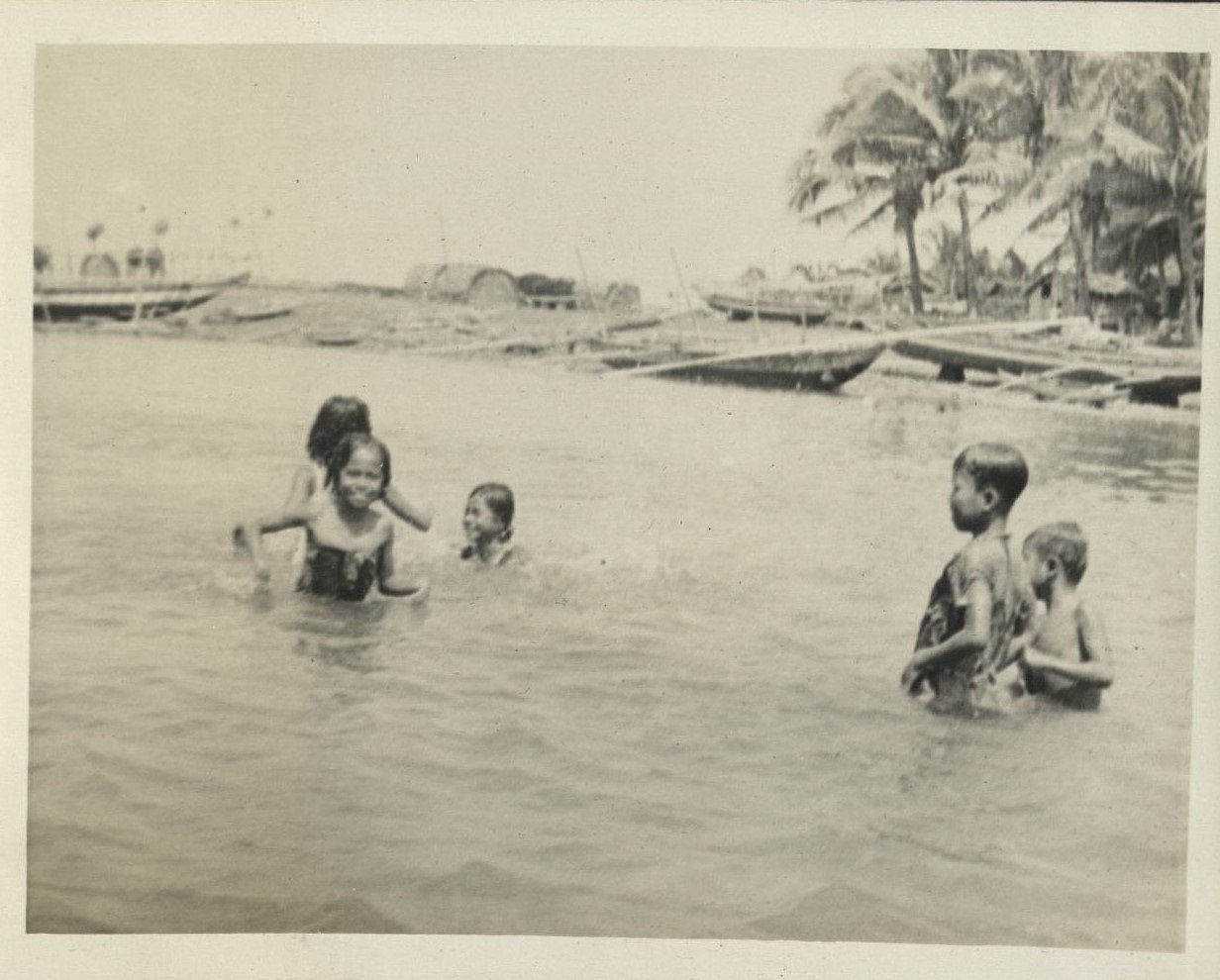 Boat trip up Taal [Pansipit] River [Children swimming in river].