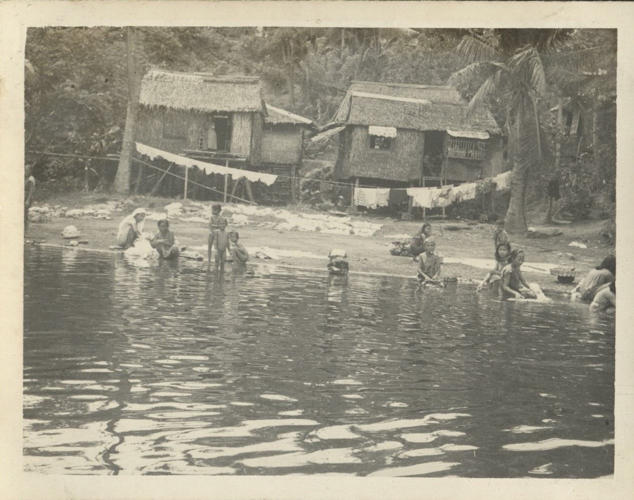 Boat trip up Taal [Pansipit] River [Laundry and bathing at a river village].