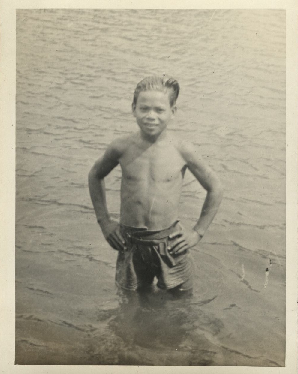 Boat trip up Taal [Pansipit] River [Filipino boy swimming in river].