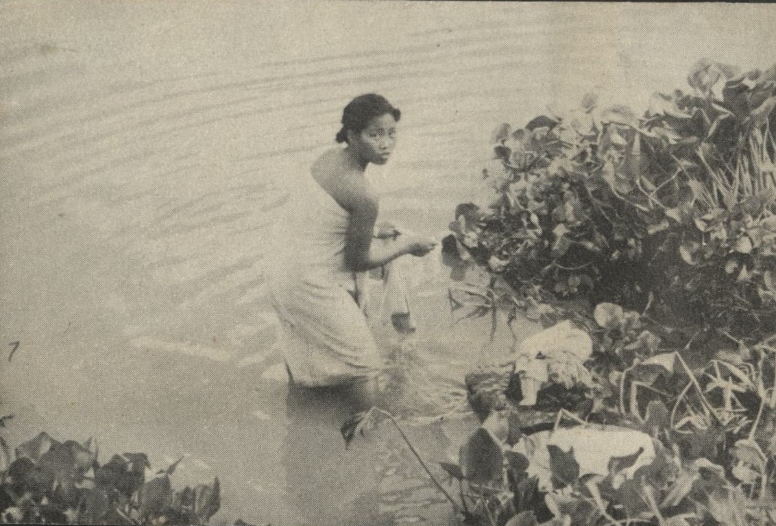 [Untitled – Filipina bathing and doing laundry in a river].
