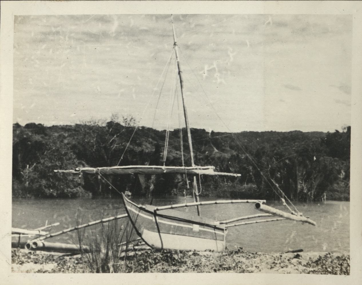 Remember Bataan? This is it. [Outrigger boat beached on riverbank].