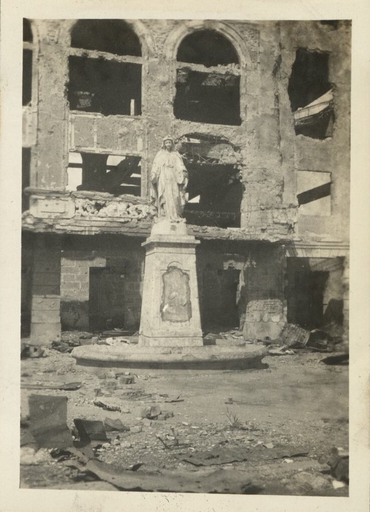 [Untitled – Statue in courtyard of destroyed college or church].