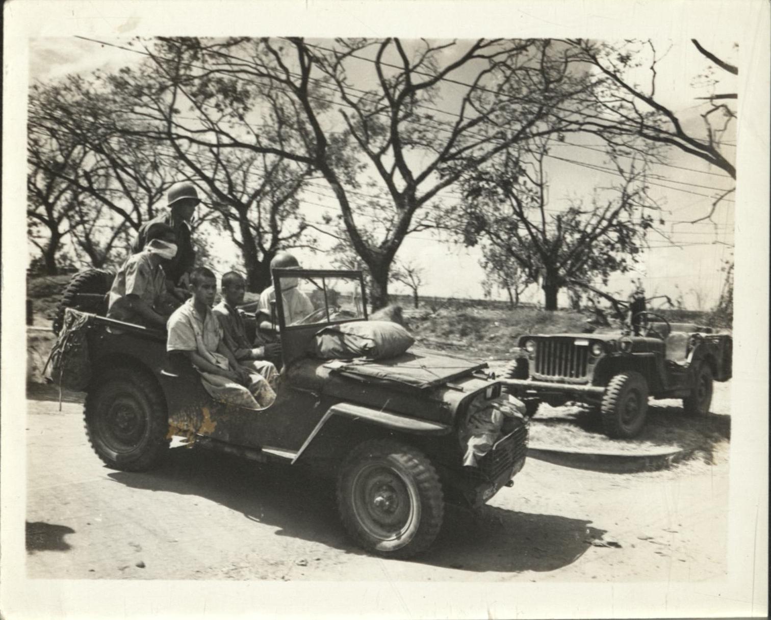 [Untitled – Soldiers in jeep evacuating civilians wounded in Manila during liberation, February 1945].