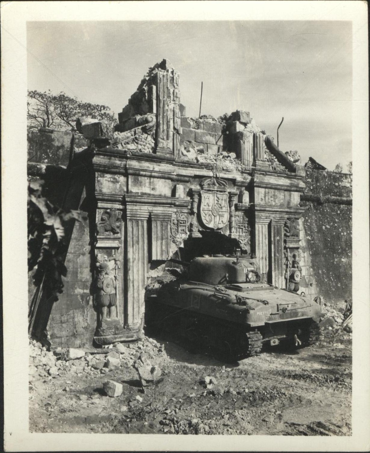 [Untitled – Urban warfare in Manila during liberation: U.S. tank enters the battered gate at Fort Santiago. February 1945].