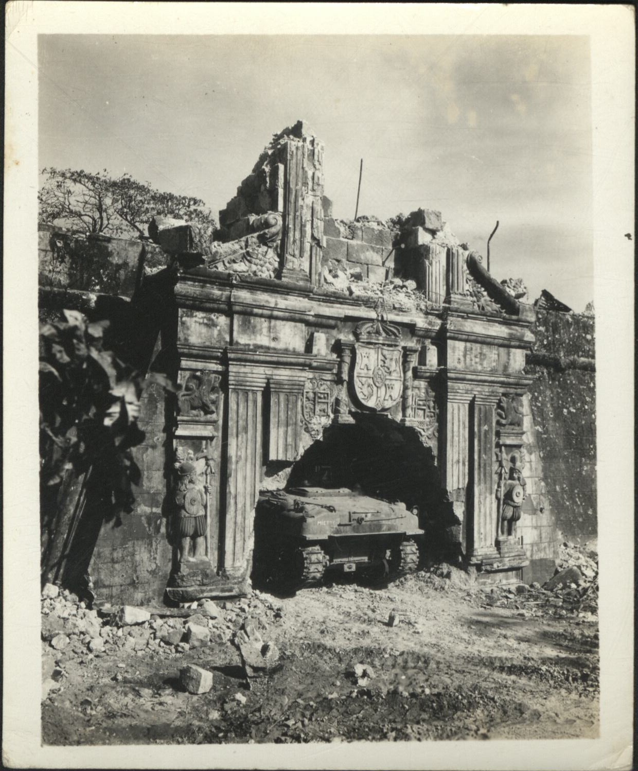 [Untitled – Urban warfare in Manila during liberation: U.S. tank enters the battered gate at Fort Santiago. February 1945].