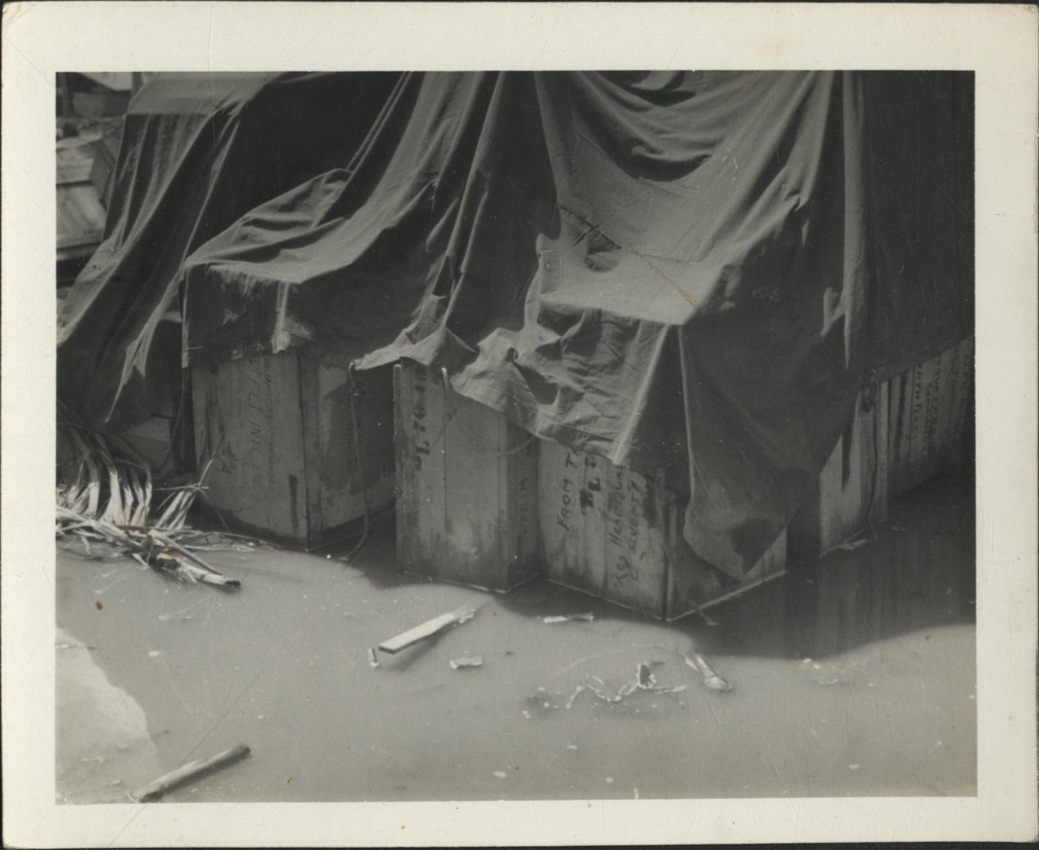 [Untitled – Military supplies crated and stacked in water, February 1945].