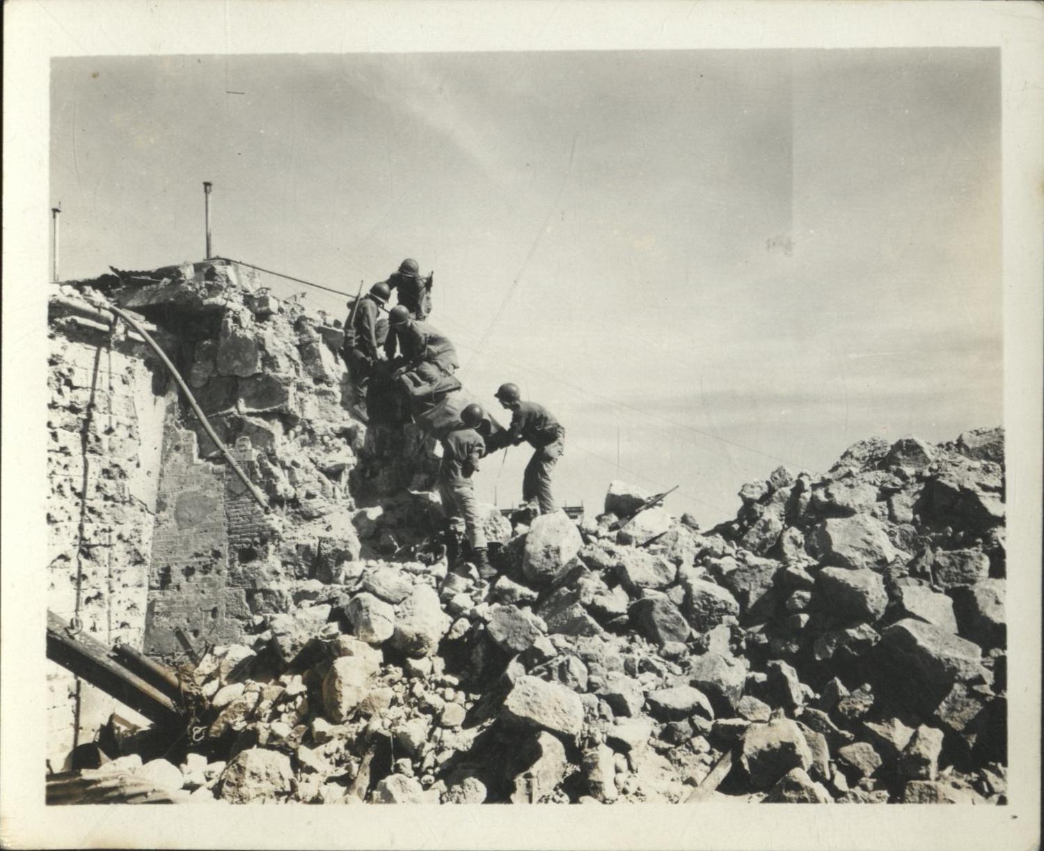 [Untitled – Urban warfare in Manila during liberation: Evacuating a casualty in Intramuros, February 1945].