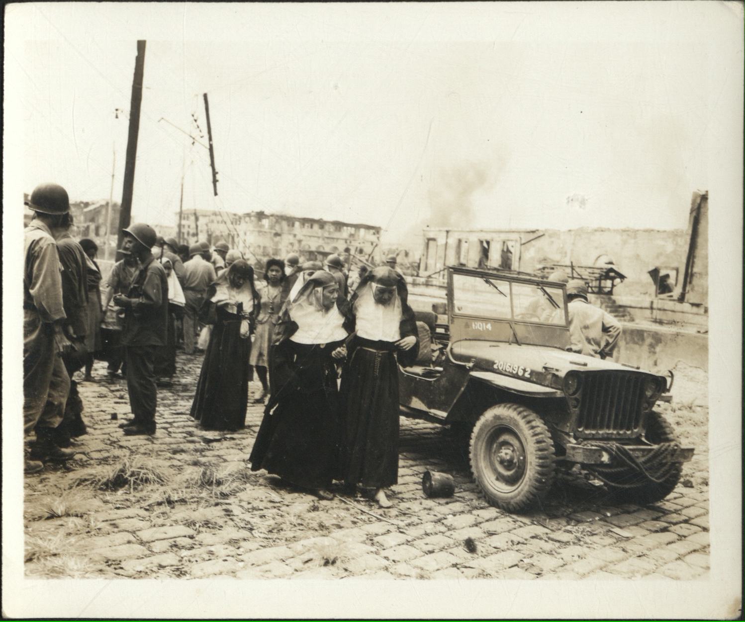 [Untitled – Urban warfare in Manila during liberation: Nuns are among the survivors in Intramuros, February 1945].