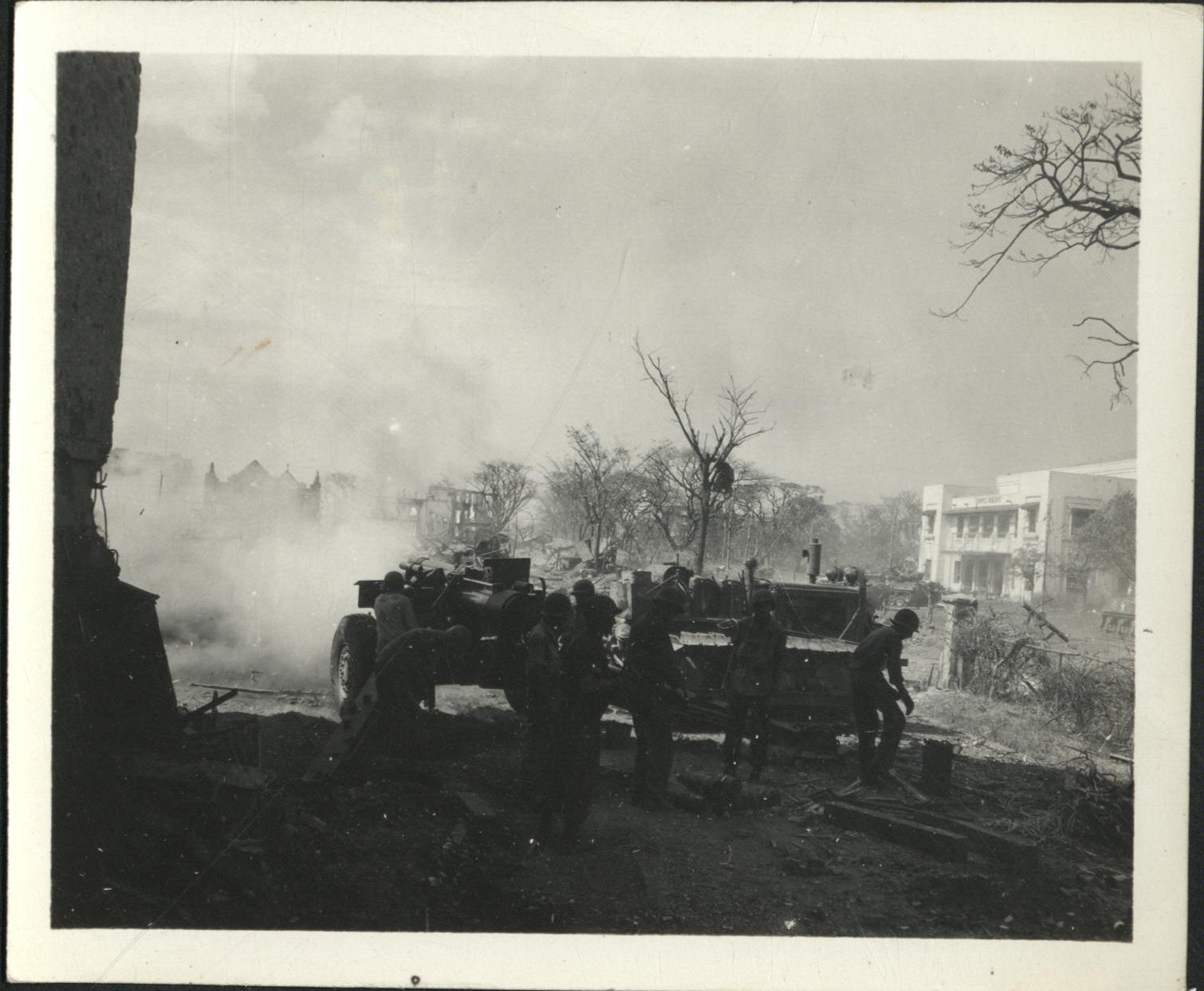 [Untitled – Destruction in Manila during liberation: Artillery firing from Legislative Building (?) toward Ermita and Central Methodist Church, February 1945].