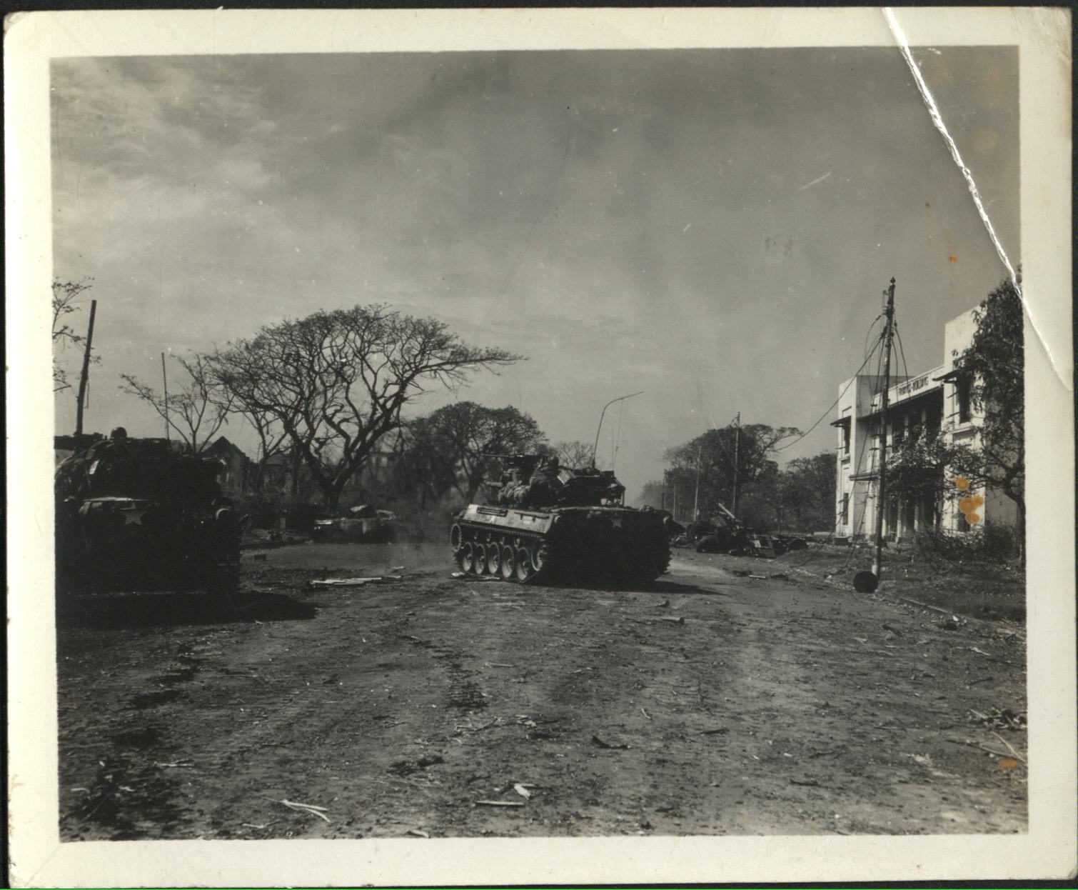 [Untitled – Fighting in Manila during liberation: Armored Personnel carrier advances in Ermita near Finance Building and Central Methodist Church, February 1945].