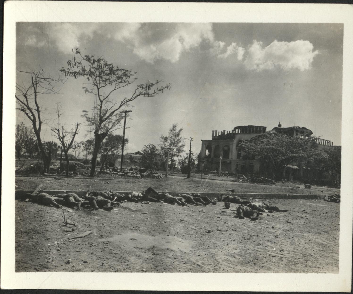[Untitled – Destruction and dead bodies in Luneta Park outside Elks Club during liberation, February 1945].