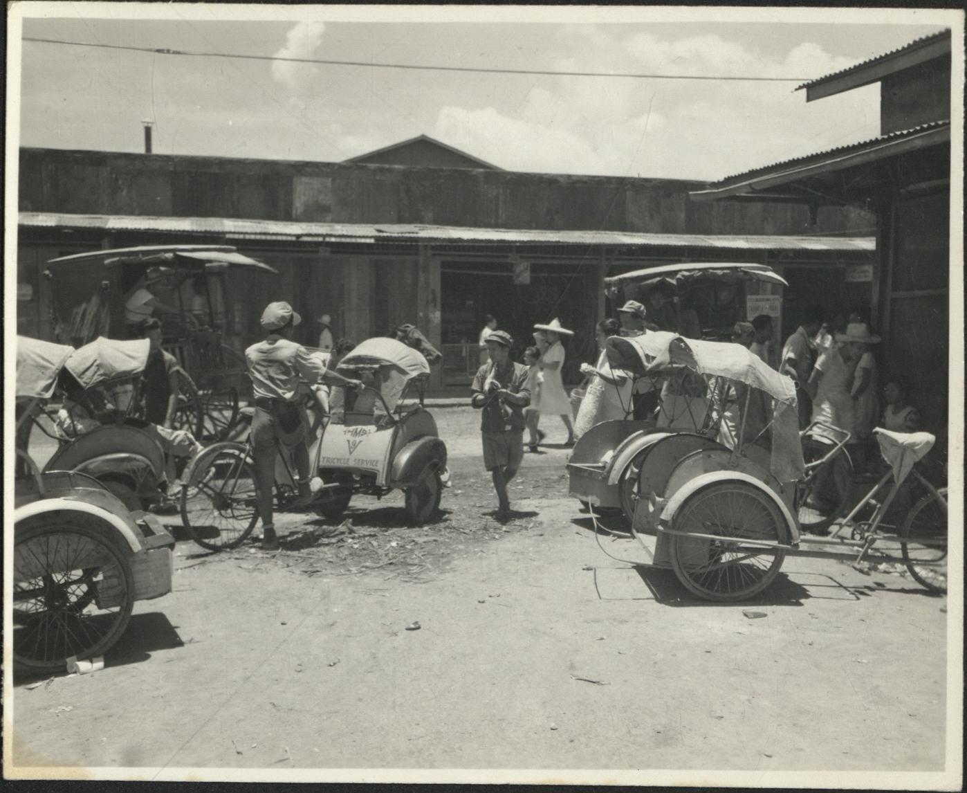 [Untitled – Manila residents during liberation: Tricycle service operating, February 1945].